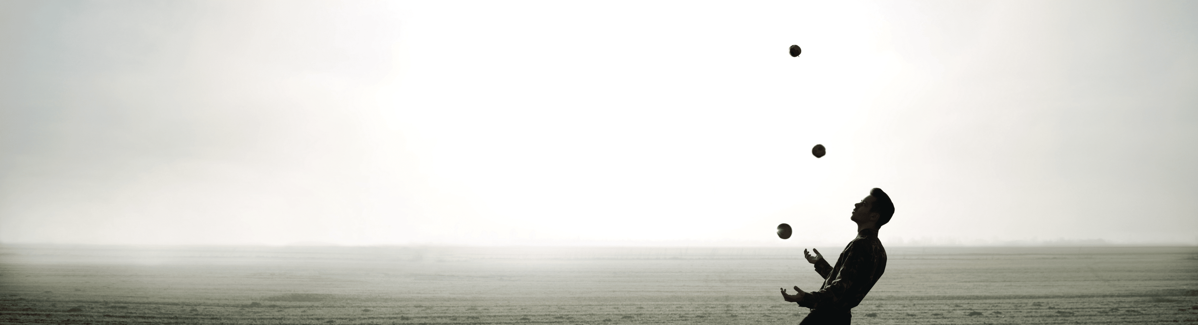 Picture of a man juggling on a beach